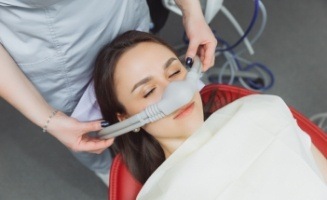 Woman in dental chair wearing nitrous oxide sedation dentistry mask