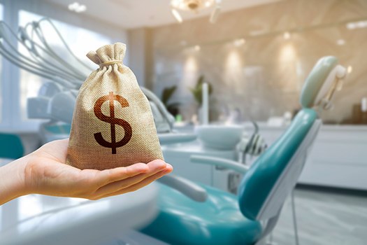 Money bag held out in front of dental chair 