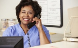 Smiling dental team member talking on phone