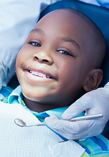 patient smiling while looking in dental mirror 