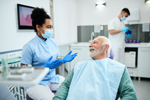 Senior patient talking to a dentist